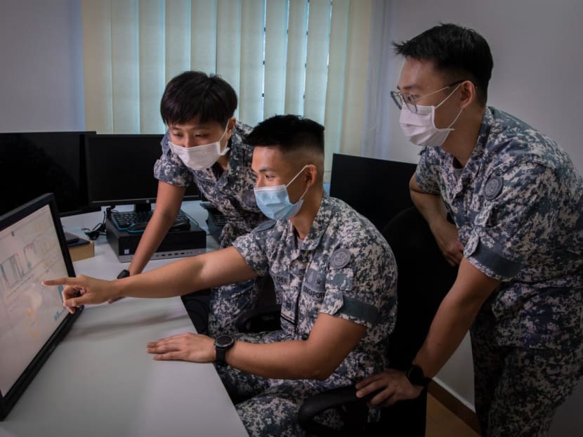 Military personnel analysing sound readings from a sensor as part of predictive maintenance for the Navy's vessels.