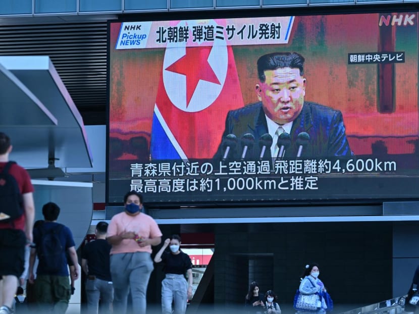 Pedestrians walk under a large video screen showing images of North Korea's leader Kim Jong Un during a news update in Tokyo on October 4, 2022. Pedestrians walk under a large video screen showing images of North Korea's leader Kim Jong Un during a news update in Tokyo on October 4, 2022.