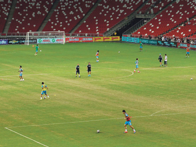 The Japanese national team training at the National Stadium on Monday. Concerns have been voiced 
over the state of the pitch.  
Photo: Wee Teck Hian