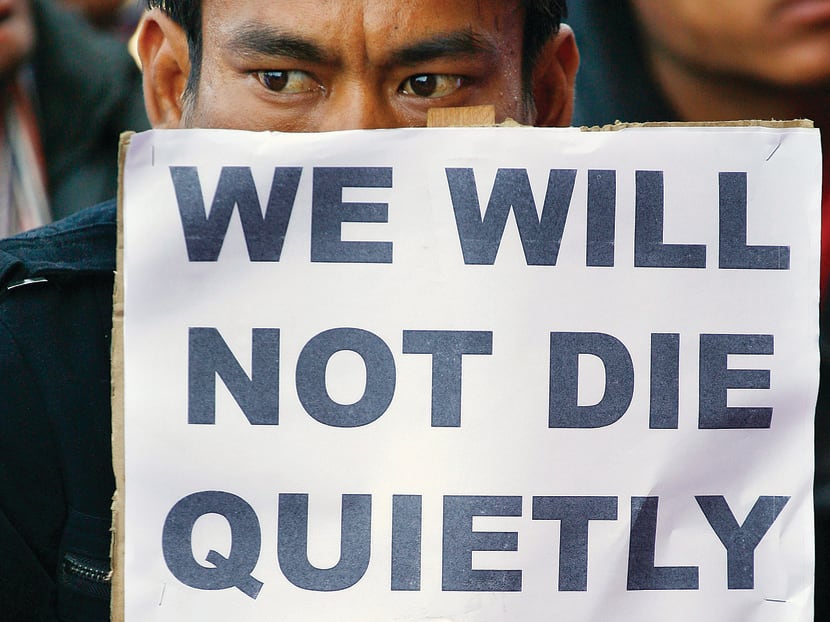 A HIV-positive person holds a placard during a programme organised to mark World AIDS Day on December 1, 2010. Photo: Reuters file photo