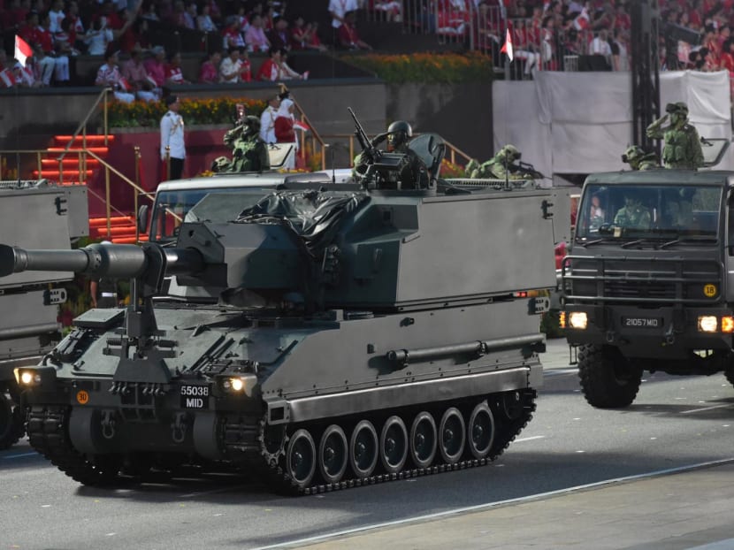 Soldiers salute from their military vehicles during the 54th National Day Parade in Singapore on Aug 9, 2019.