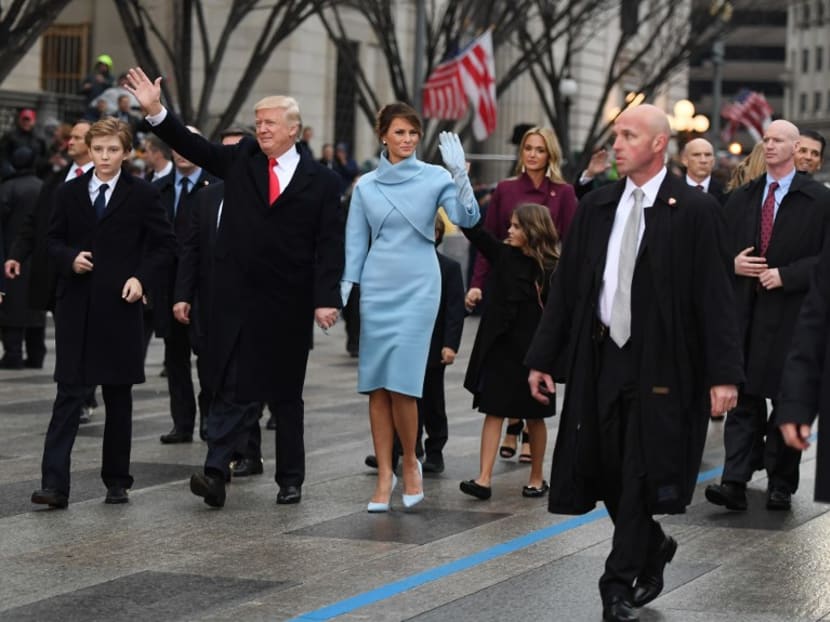 United States President Donald Trump and First Lady Melania walking the inaugural parade route with son Barron. Photo: AFP