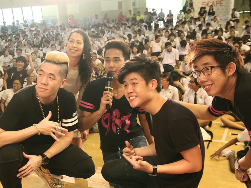98.7FM DJs posing with ShiGGa Shay (left) and Gentle Bones (second from right) in front of students from Bishan Park Secondary School at the launch of *SCAPE Invasion Tour yesterday. Photo: Jaslin Goh