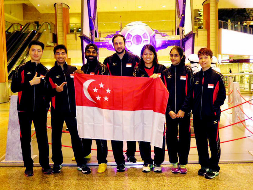 (Second from left) National players Samuel Kang, Vivian Rhamanan, coach Ibrahim Gul (centre) and their team mates. Gul plans to introduce an innovative training and playing technology to get young people and adults playing — and hooked on — the sport here. Photo: Singapore Squash Rackets Association