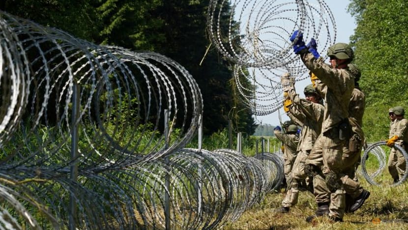 Poland says Belarus lets migrants cross border in 'hybrid war' with EU Poland says Belarus lets migrants cross border in 'hybrid war' with EU