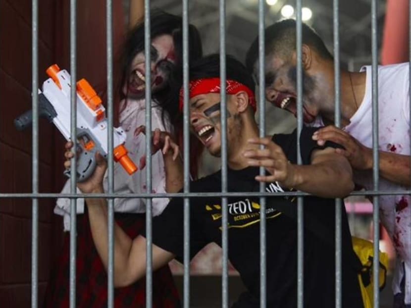 Battle zombies using Nerf guns in a survival game at the National Stadium