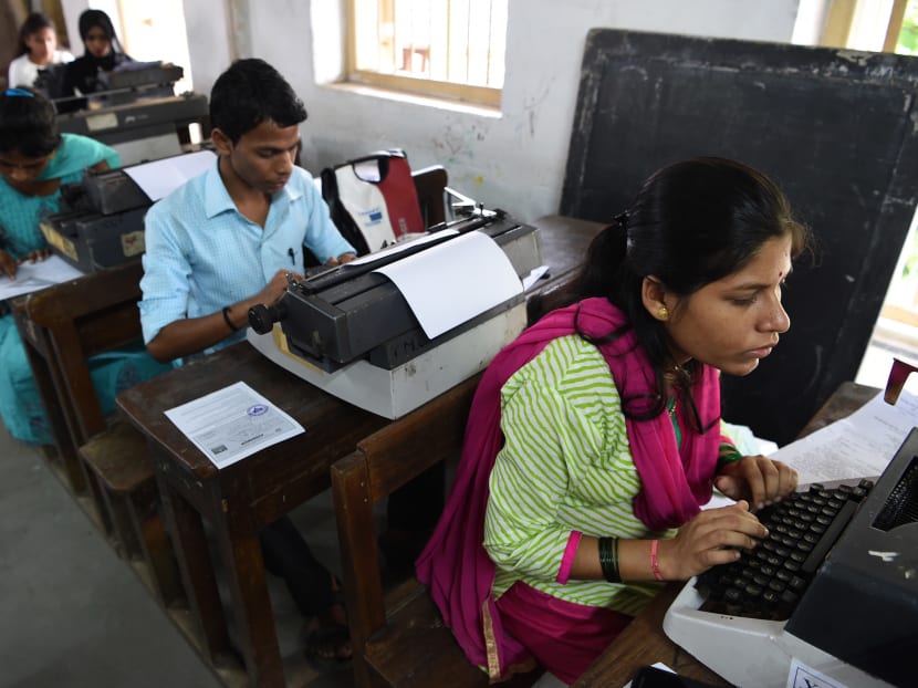 Candidates use typewriters during the last official typing exam conducted by the state government in Mumbai. Photo: AFP