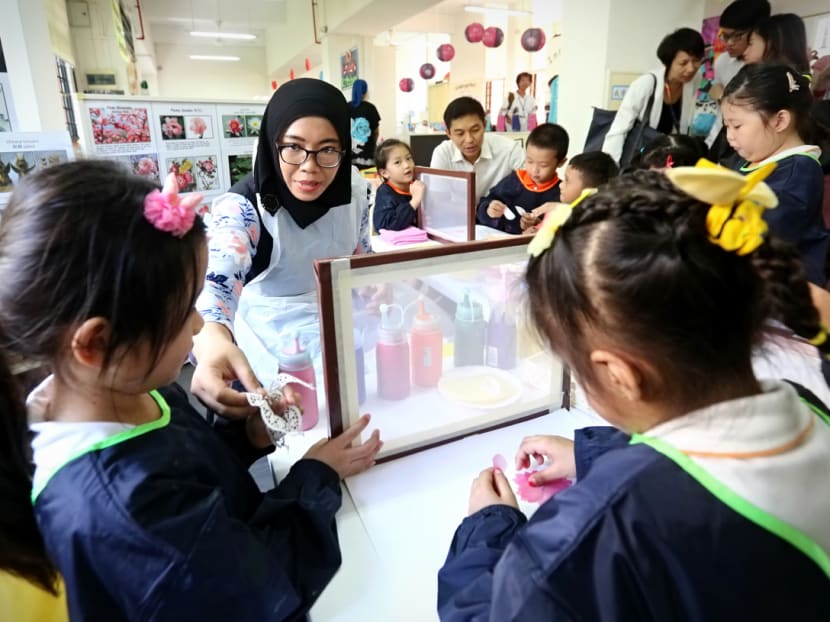 Ms Nurulhuda Binte Rahmat, 29, teacher at My First Skool (Haig Road), conducts a silk screen printing session on Sept 9, 2016, one of the projects done as part of a Professional Development Programme (PDP) by the Early Childhood Development Agency. Photo: Nuria Ling/TODAY