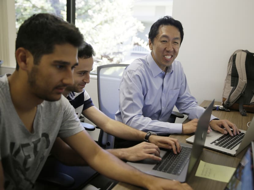 Computer scientist Andrew Ng, right, works with others at his office in Palo Alto, Mr Ng, one of the world's most renowned researchers in machine learning and artificial intelligence, is facing a dilemma: there aren't enough experts trained to train the machines. Photo: AP