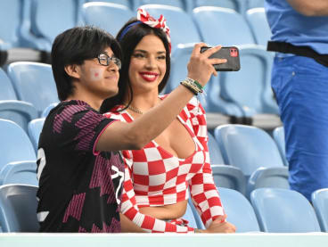Croatian influencer Ivana Knoll poses for selfies with a Japan supporter ahead of the start of the Qatar 2022 World Cup round of 16 football match between Japan and Croatia at the Al-Janoub Stadium in Al-Wakrah, south of Doha on Dec 5, 2022.

