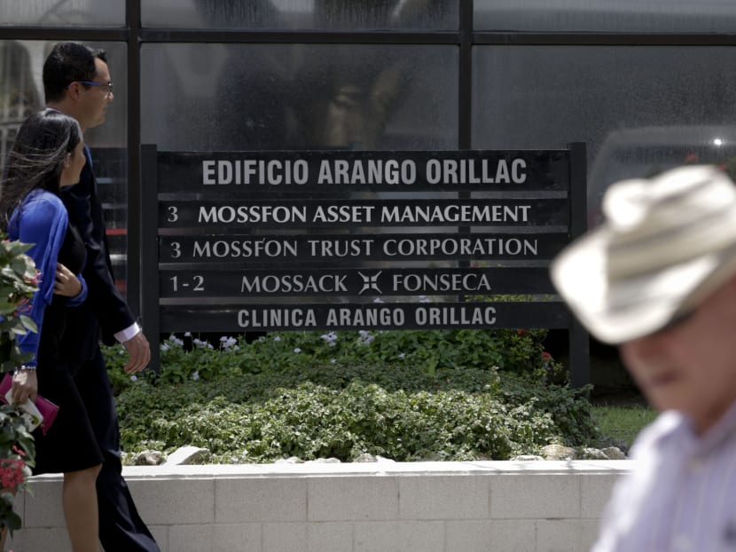 People walk past the Arango Orillac Building which lists the Mossack Fonseca law firm in Panama City, on April 5, 2016. Photo: AP