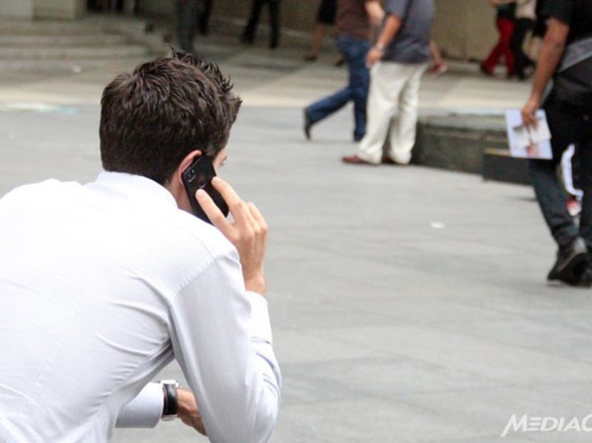 A man uses his phone in the central business district in Singapore. Photo: Channel NewsAsia