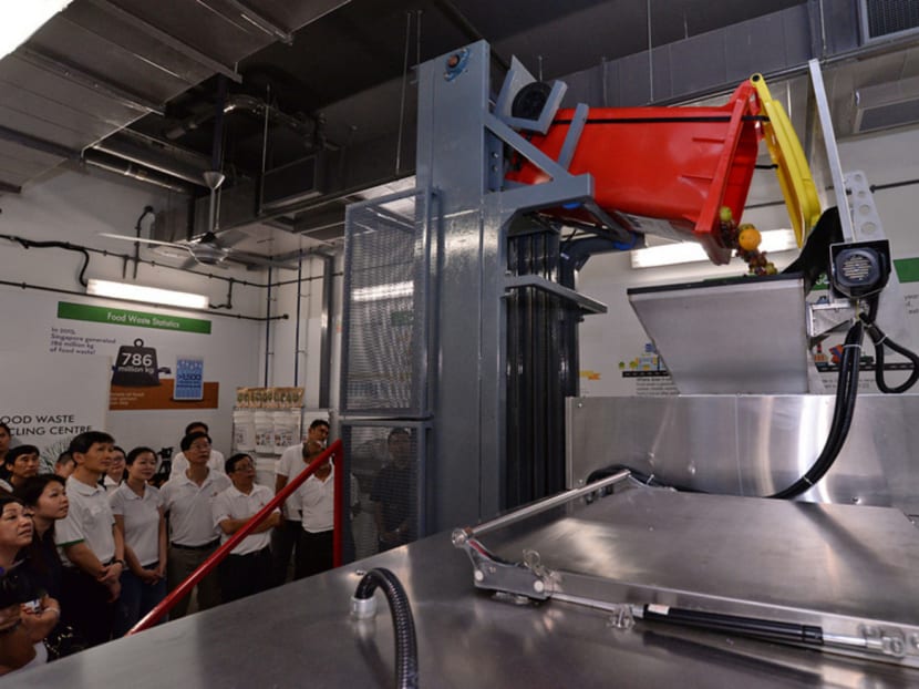 Invited guests of the official opening of Our Tampines Hub Phase 1 observing a live demonstration of how the ecoHybridDigester System, an advanced food waste recycling system, functions at Our Tampines Hub. Photo: Robin Choo/TODAY