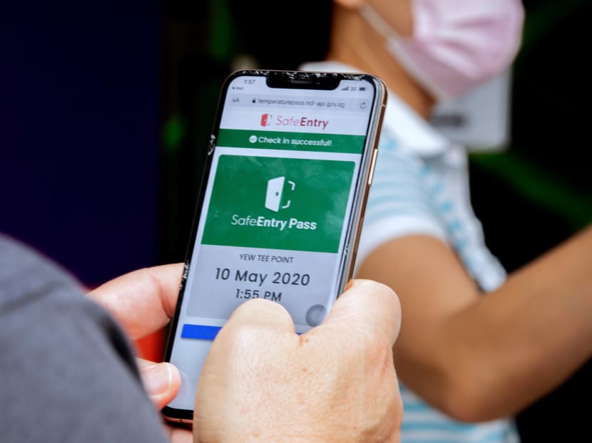 A visitor using the SafeEntry application on a smartphone. Some businesses use SafeEntry for check-ins but not for checking out, Member of Parliament Melvin Yong said.