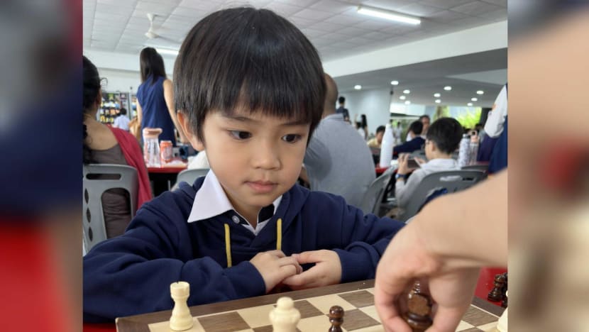 Grown men play chess using a watch to control time