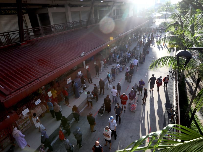 A view of the Geylang Serai market at 8am on May 21, 2020, when there were long queues at both its entrances.