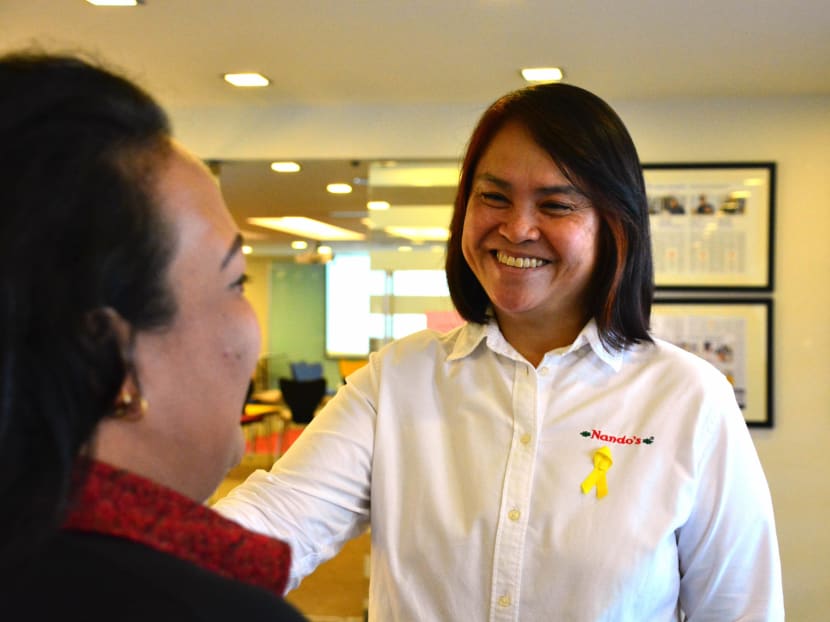 CEO of Nando’s Chickenland Ms. June Koh together with ex-offender employee Ms Moon. Photo: Singapore Prison Service