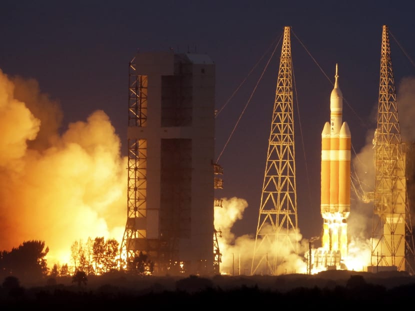 NASA's Orion spacecraft, atop a United Launch Alliance Delta 4-Heavy rocket, lifts off on its first unmanned orbital test flight from the Cape Canaveral Air Force Station Dec 5, 2014, in Cape Canaveral. Photo: AP