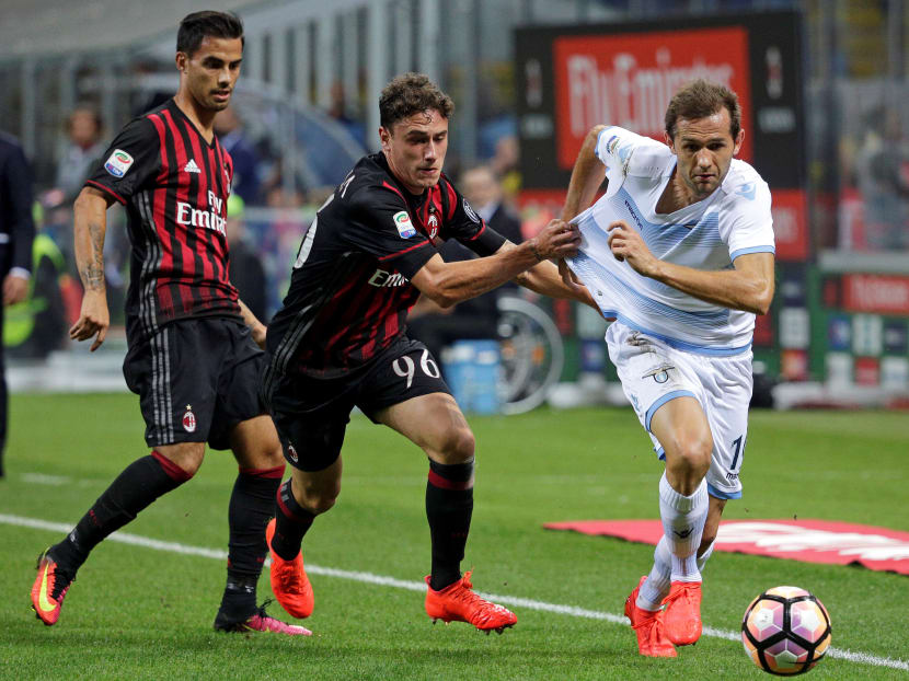 Not so fast: The Chinese company seeking to buy the AC Milan football team (seen here in red and black) may have given a false bank report. Photo: Reuters
