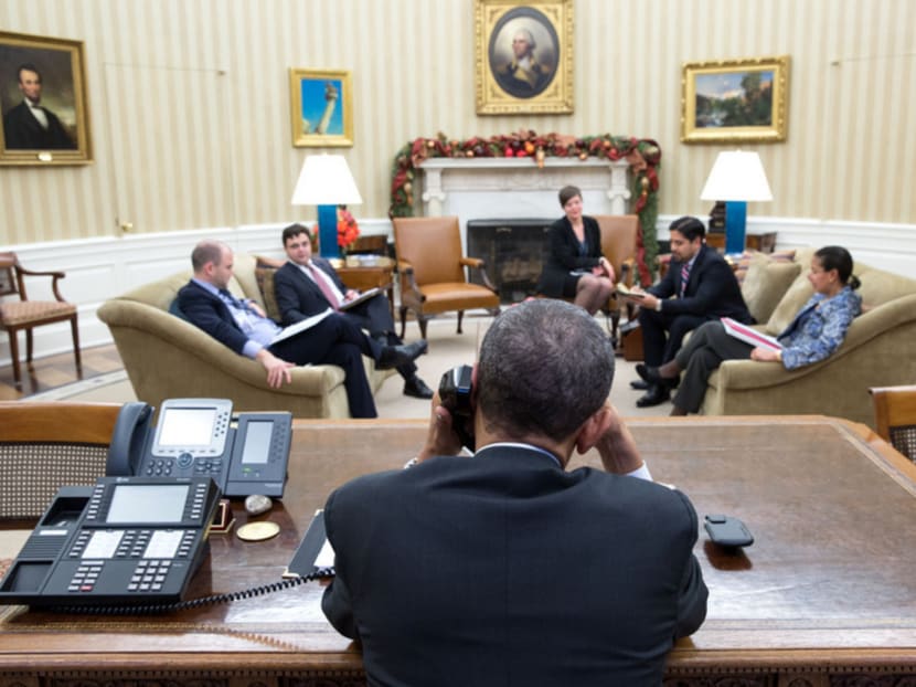 In a handout photo, President Barack Obama speaks on the phone with President Raul Castro of Cuba, one day before the announcement of restored diplomatic relations, in the Oval Office of the White House in Washington, Dec. 16, 2014. Photo: The White House