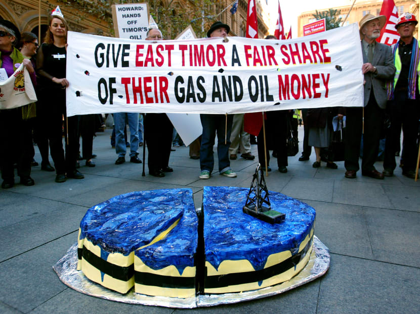File picture of protesters holding banners urging the Australian government to strike a fair deal with East Timor amid disputes over gas and oil reserves. Media reports say the Asian nation could earn a maximum 80 per cent revenue from a S$53.04 billion offshore gas project under a yet-to-be-announced deal with Australia. Photo: Reuters