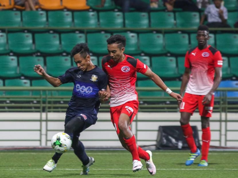 Faris Ramli (right) trying to get away from Hougang United's Nazrul Nazari during their clubs' clash at the Jalan Besar Stadium. PHOTO: S.League