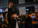 People sing slogans while gathering on a street in Shanghai on Nov 27, 2022, where protests against China's zero-Covid policy took place the night before following a deadly fire in Urumqi, the capital of the Xinjiang region.