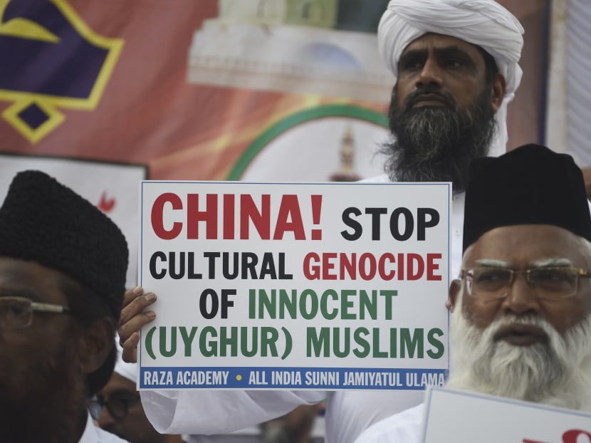 Indian Muslims hold placards as they protest to denounce the Chinese government's policies for Uighur Muslims in Xinjiang in Mumbai on Dec 9, 2019.