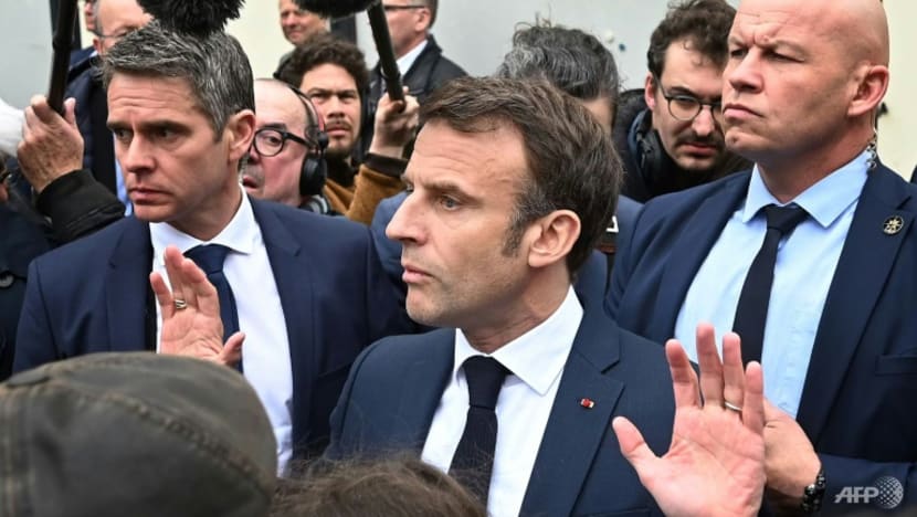 Macron booed by angry French after signing pensions reform