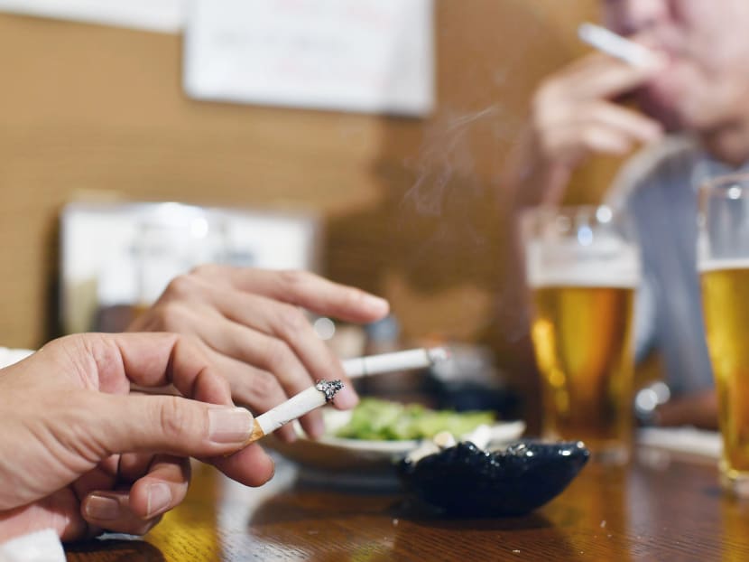 People smoking in a restaurant in Tokyo, Japan. Planned legislation to address passive smoking by banning lighting up in restaurants is in limbo following strife between Japan’s health ministry and the ruling party. Photo: Kyodo News