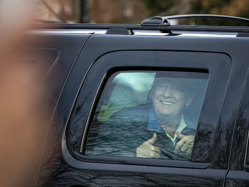 US president Donald Trump gives a thumbs up towards supporters as he departs Trump National Golf Club on Dec 13, 2020 in Sterling, Virginia.