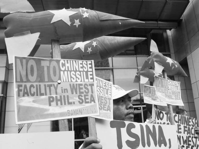 Activists display mock missiles as they picket the Chinese Consulate in the Philippines to protest against the alleged military build-up on South China Sea islands. Photo: AP