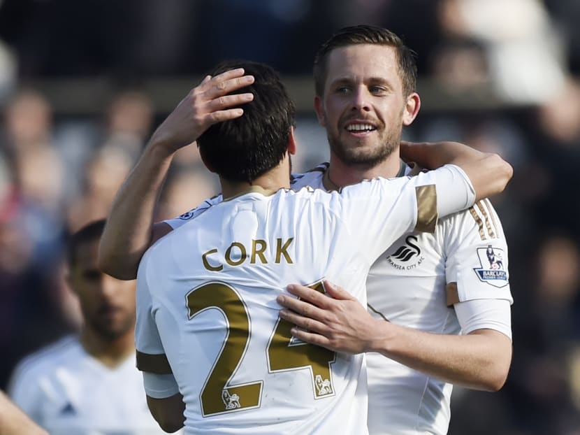 Swansea's Gylfi Sigurdsson celebrates with Jack Cork at the end of the game against Chelsea. Photo: Reuters