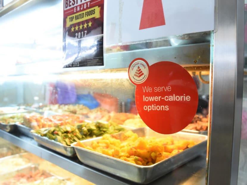 Consumers can identify stalls with healthier food options through the labels at the stalls. These meals are 500 calories and below, compared with between 700 and 800 calories for other meals. Photo: Health Promotion Board