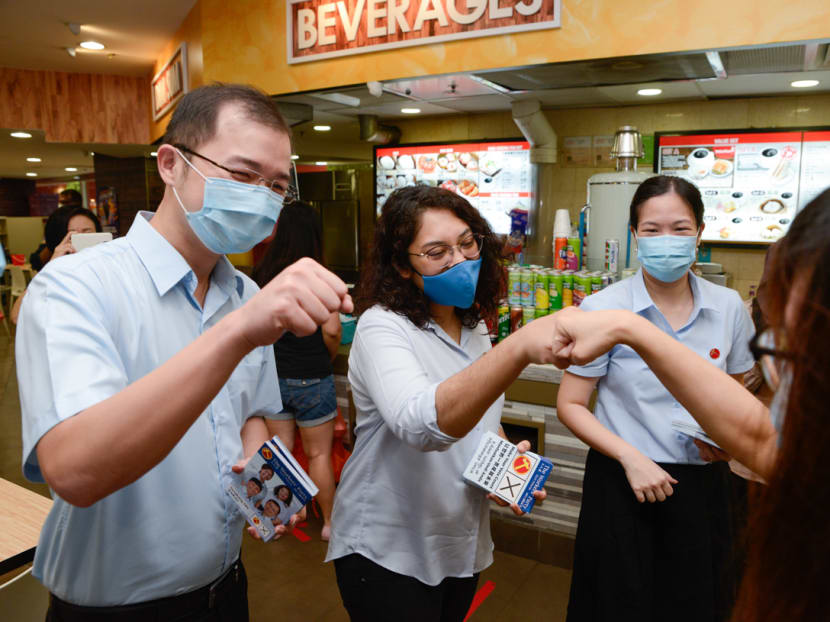 From left to right: Mr Louis Chua, Ms Raeesah Khan and Ms He Ting Ru from the Workers' Party greeting residents at Rivervale Plaza in Sengkang on July 7, 2020.