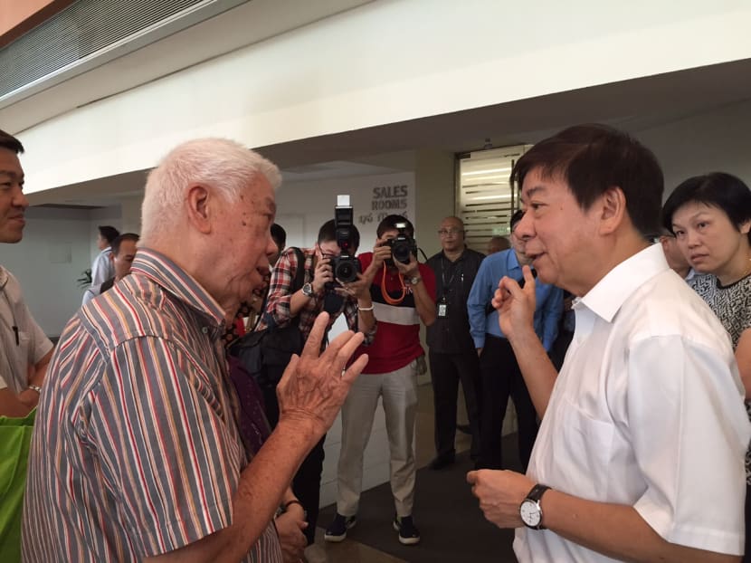 Minister Khaw meeting with an elderly Singaporean after the doorstop at HDB Hub in Toa Payoh. Photo: Laura Elizabeth Philomin