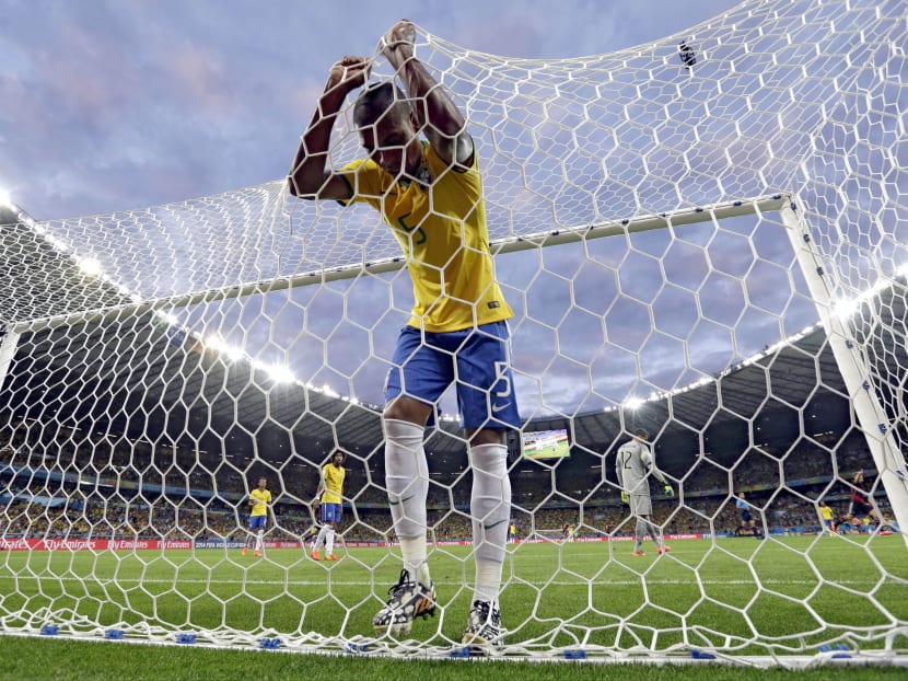 Brazil's Fernandinho reacts after Germany's Toni Kroos scored his side's third goal during the World Cup semi-final soccer match loss to Germany at the Mineirao Stadium in Belo Horizonte, Brazil on July 8, 2014. Photo: AP