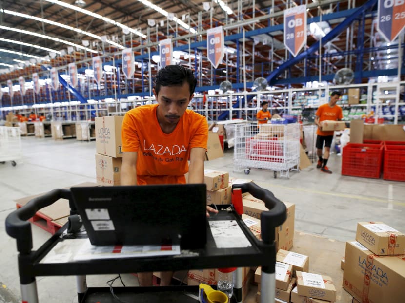 An employee at online retailer Lazada preparing orders at the company’s warehouse in Jakarta, Indonesia. In April, Chinese e-commerce giant Alibaba agreed to buy a controlling stake in privately owned Singapore company Lazada. Photo: Reuters