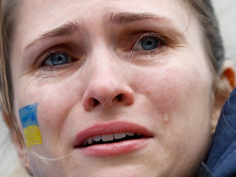 A woman cries during a pro-Ukrainian demonstration near Downing Street, in London, Britain on Feb 24, 2022.  