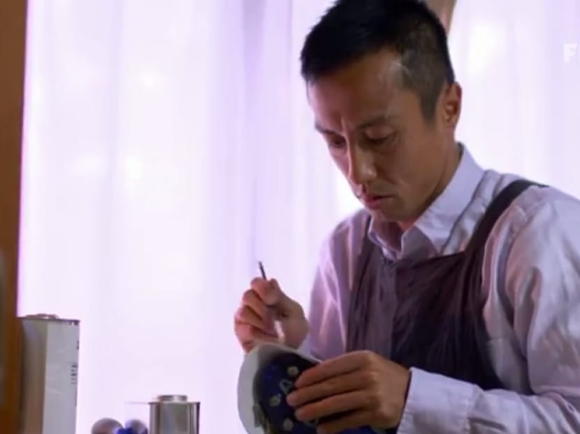 Former S.League star Ryuji Sueoka working on an old football boot that he will repair and send to needy children in India. Source: Screengrab from Youtube