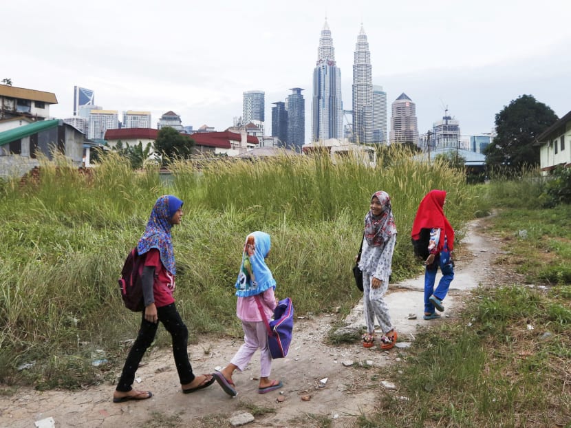 Girls make their way home after school in Kuala Lumpur, Malaysia, Feb 10, 2016. Photo: Reuters