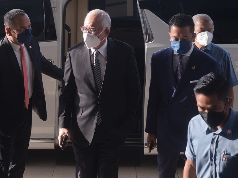 Najib Razak (centre) arriving at the Kuala Lumpur High Court on Oct 26, 2021.