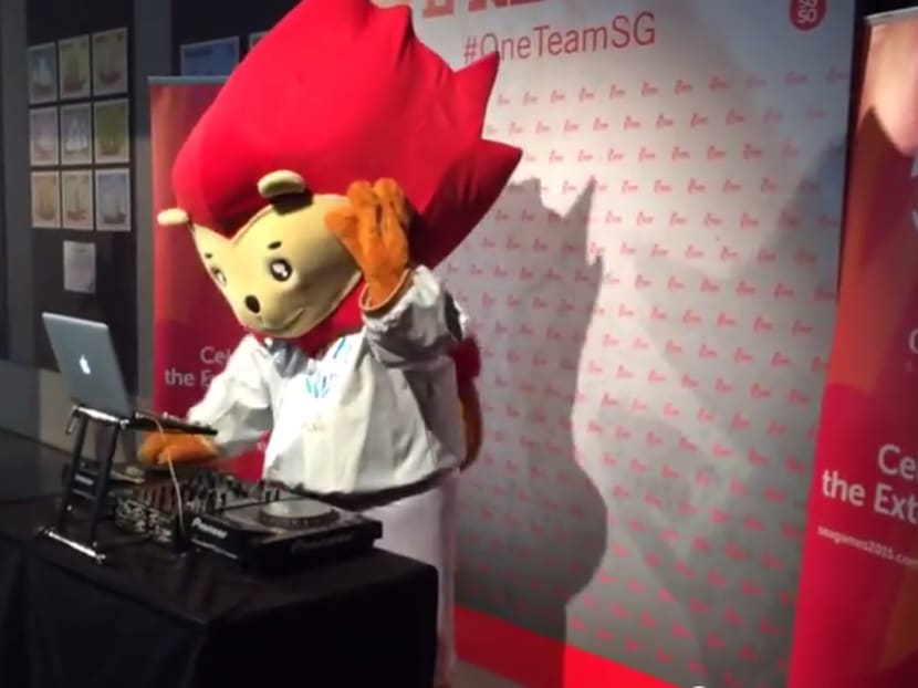 Official mascot of the SEA Games 2015, Nila, spins on the DJ decks at the unveiling of the official victory medal design for athletes,