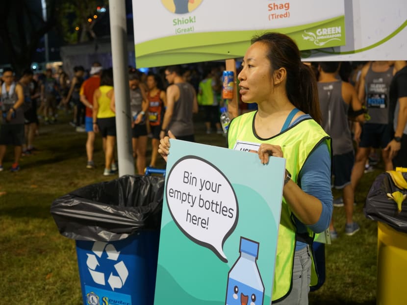 Green Nudge volunteers direct participants to chuck recyclables in the correct bins at the OSIM Sundown Marathon in May 2018.