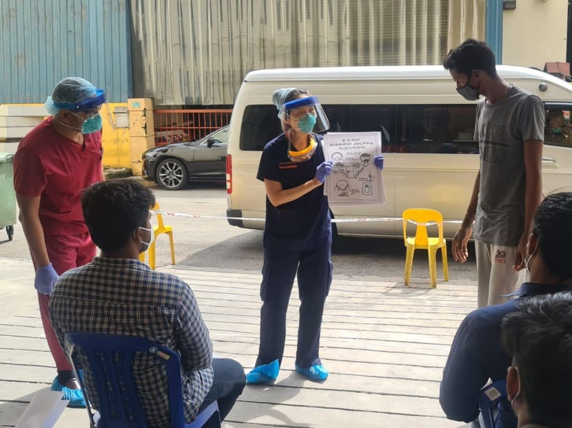 The author engaging migrant workers at a dormitory on May 29 2020 in an interactive health engagement activity to empower them to be health ambassadors.