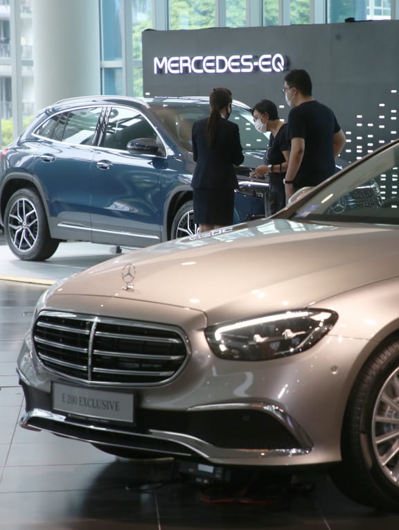 Visitors viewing a car at the C&C Mercedes-Benz Center on April 10, 2022.