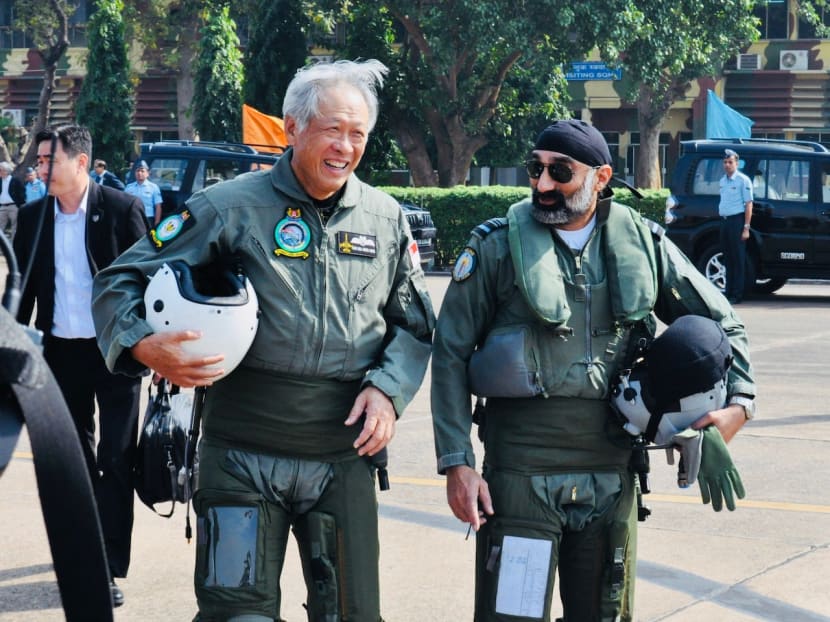 Dr Ng (left) accompanied by Air Vice Marshal A P Singh(right) as they prepare to board the Indian Air Force’s Tejas Light Combat Aircraft during his visit to the JMT. Photo: MINDEF