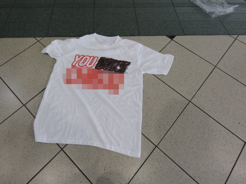 A tee-shirt with an expletive was found outside the premises of Mobile Air at Sim Lim Square on Nov 6. Photo: Don Wong