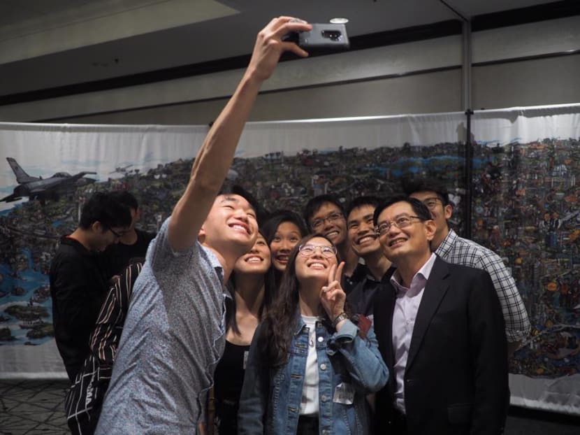 The author says that we can expect Finance Minister Heng Swee Keat, seen here with Singaporeans at a reception in San Francisco in April, to take on a higher profile from next month as the leadership spotlight shifts gradually from PM Lee.
