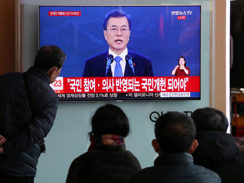 People watch a TV broadcasting South Korean President Moon Jae-in's speech during his New Year news conference, in Seoul, South Korea. Mr Moon credits United States President Donald Trump for helping to spark the first inter-Korean talks in more than two years, and warned that Pyongyang would face stronger sanctions if provocations continued. Photo: Reuters